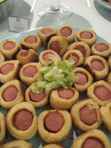 a plate of hot dogs with lettuce on top at Camaçari Plaza Hotel in Camaçari