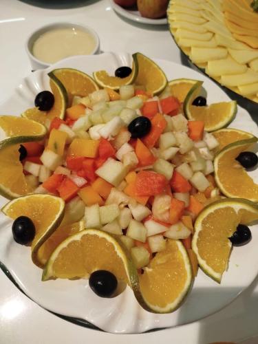 a plate of fruit and vegetables on a table at Camaçari Plaza Hotel in Camaçari