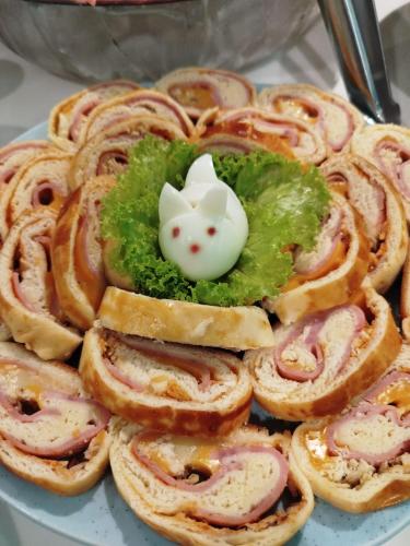 a plate of food with onion rings and broccoli at Camaçari Plaza Hotel in Camaçari
