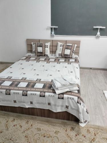 a bedroom with a large bed in a room at Aerodrom Hotel in Almaty