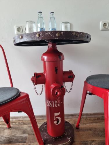 a table with drinks on top of a fire hydrant at CJS Apartments - Chill or Drive am Nürburgring, Free Parking, WLan, Spacious Rooms, Quiet Location in Rodder