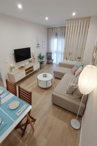 a living room with a couch and a table at Apartamento Sotavento - 2 dormitorios in Chipiona