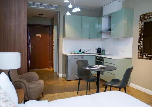 a kitchen with a table and chairs in a room at Accra Luxury Apartments @ Pearl in Accra