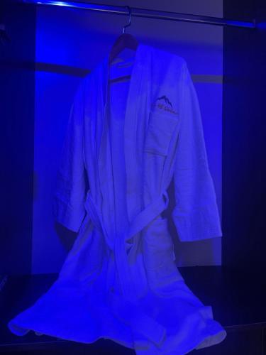 a jacket hanging in a room with a blue light at Morgan Hill Residence in Abuja