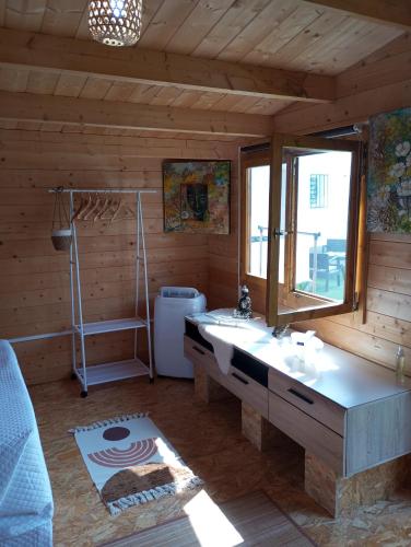 a bathroom with a sink and a window at Nüa Relax in San Vicente de Calders