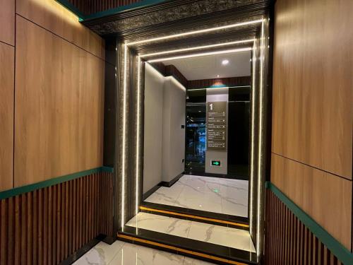 a hallway with a mirror in a elevator at Bona Ventura Hotel & Skybar in Tanjung Pinang 