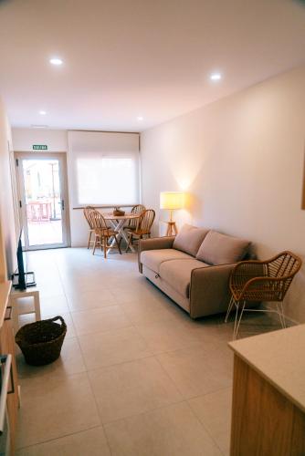 a living room with a couch and a table at Apartamentos Costa Norte in San Vicente de la Barquera