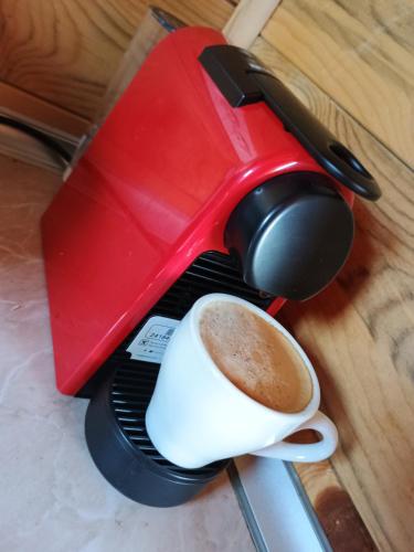 a coffee maker with a cup of coffee at Vikendica sa bazenom Čarolija Kruševac in Kruševac