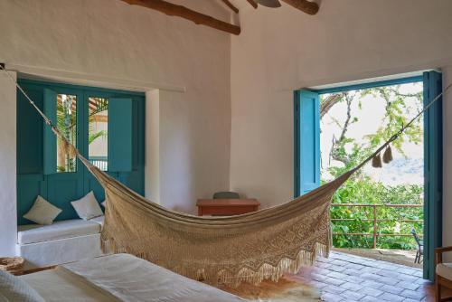 a hammock in a room with a window at Casa Barichara Boutique in Barichara