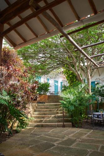 a set of stairs leading up to a building with trees at Casa Barichara Boutique in Barichara