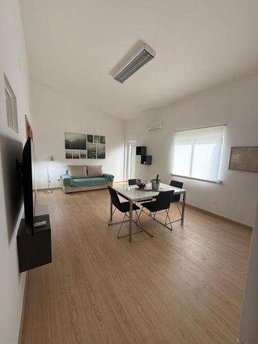 a living room with a table and chairs and a couch at My Dream in Penha Garcia