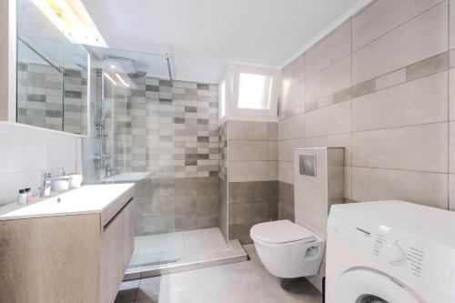 a bathroom with a toilet and a sink and a shower at Sonia's Maison in Limenas