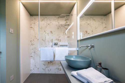 a bathroom with a blue bowl sink on a counter at Villa Sawian in Appiano sulla Strada del Vino