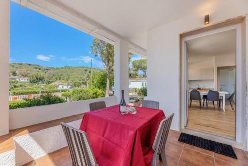 a dining room with a table with a red table cloth at Camping Europa in Capoliveri