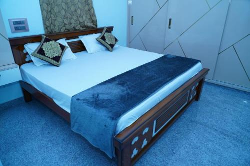a bedroom with a large bed in a room at Madhava Home Stay in Tirupati