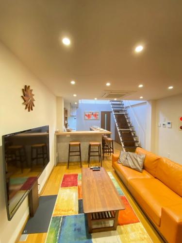 a living room with a couch and a table at 城崎 柳通り ゆるり-Yururi- in Toyooka