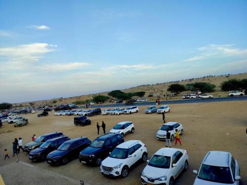 a group of cars parked in a parking lot at Melody Moon Desert Camp & Resort in Jaisalmer