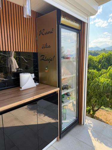 a restaurant with a table and a glass door at Ranc Cika Zlaje in Vitez