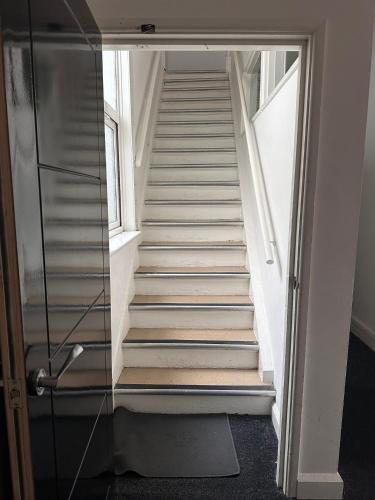 a staircase with a glass door leading up to a stair case at Shakespeare's Stay in Stratford-upon-Avon