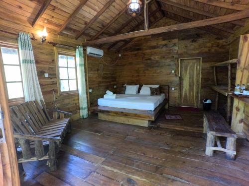 a bedroom with a bed in a wooden cabin at Tree Nest Sigiriya in Kibissa