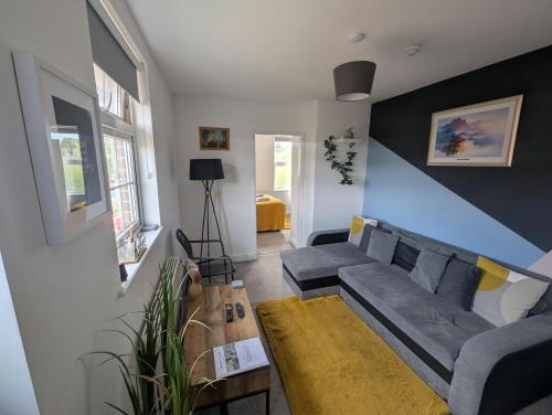a living room with a couch and a table at Shakespeare's Stay in Stratford-upon-Avon