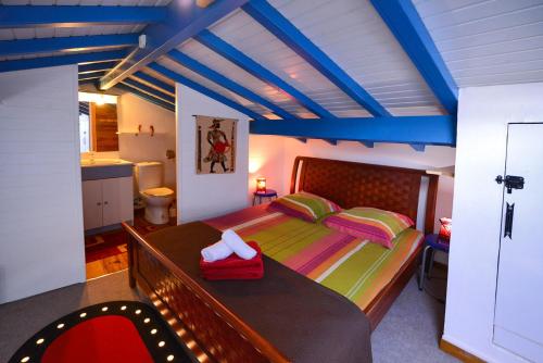 ein Schlafzimmer mit einem großen Bett mit blauer Decke in der Unterkunft kay betty in Les Trois-Îlets