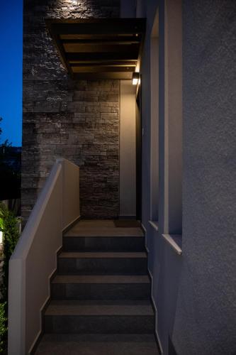 a staircase leading up to a building with a stair light at Neutral Haven in Nafplio