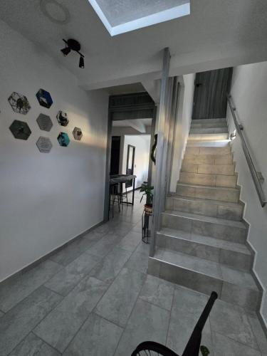 a hallway with a staircase and a stair case at Pipe's House in Salento