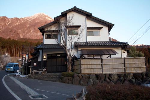 a house on the side of a road at Yufuin Country Road Youth Hostel in Yufuin