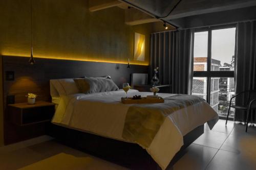 a bedroom with a large bed with a table on it at Mali Experience in Rionegro