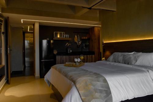 a bedroom with a large bed and a refrigerator at Mali Experience in Rionegro