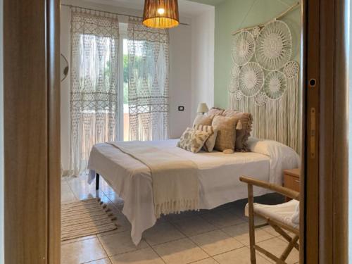 a bedroom with a bed and a large window at La Farfalla in Fossacesia