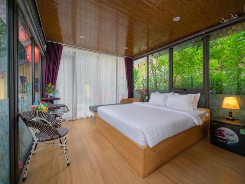 a bedroom with a large bed and a window at Hoang Minh Mountainside Villa in Ninh Binh