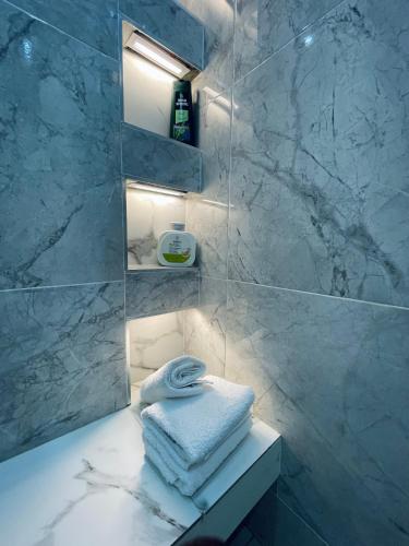a bathroom with a sink with towels on a counter at Platinum Blue Island Resort in Atimpoko