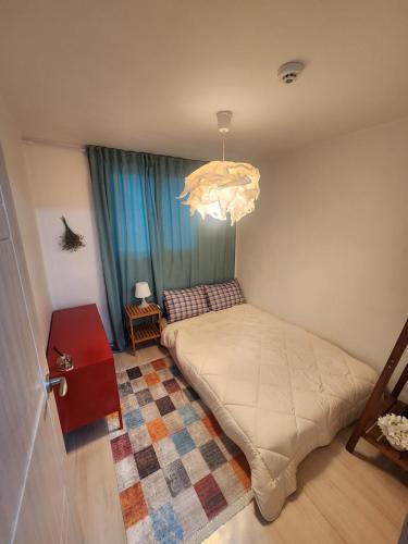 a bedroom with a bed and a chandelier at Daon 101 in Seoul