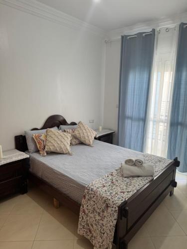 a bedroom with a bed with two shoes on it at Apartamento de lujo Martil in Martil