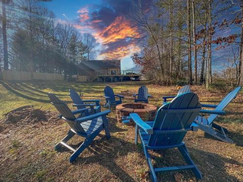 a group of blue chairs sitting around a fire pit at Spa Lodge Sleeps 9 Sauna Hot Tub Mtn Views in Fletcher