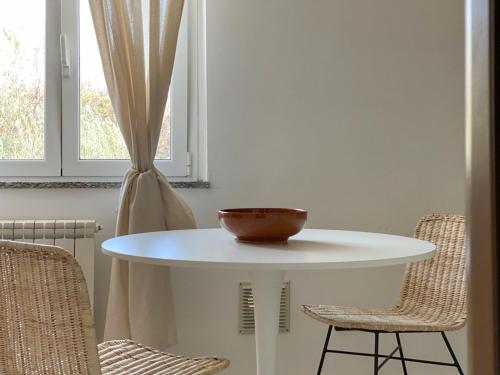 a white table with a bowl on top of it at La Farfalla in Fossacesia