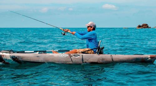 a man fishing in a boat in the water at Summer Salt Beach Casita in Punta Mita