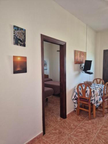 a living room with a table and a mirror at Casa Cira in Calera