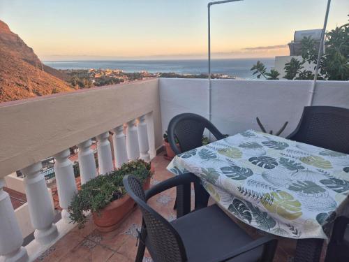 a table and chairs on a balcony with a view at Casa Cira in Calera