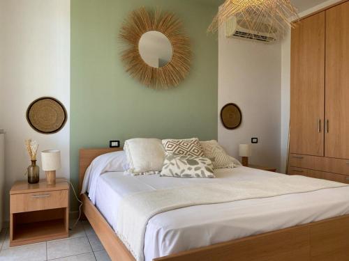 a bedroom with a bed with a mirror on the wall at La Farfalla in Fossacesia