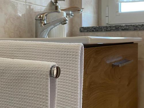a bathroom sink with a white towel on a counter at La Farfalla in Fossacesia