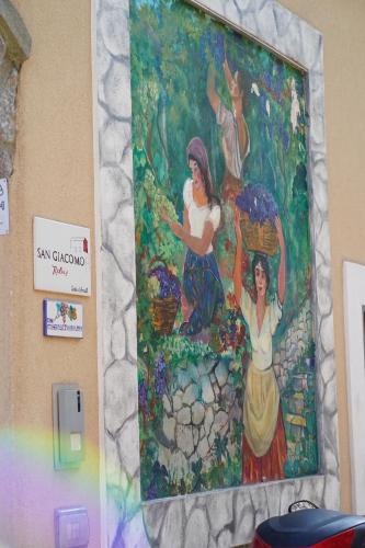 a painting of women on a wall at San Giacomo Relais in Furore