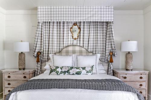 a bedroom with a bed with two night stands and two lamps at Hotel Lulu in Round Top
