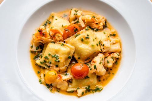 a white bowl of food with shrimp and vegetables at Hotel Lulu in Round Top