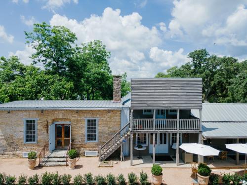 an exterior view of a brick building with a porch at Hotel Lulu in Round Top