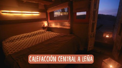 a small room with a bed and a sign at Narakan Cabo Polonio in Cabo Polonio