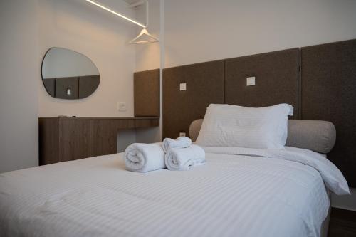 a bedroom with a bed with towels on it at Neutral Haven in Nafplio