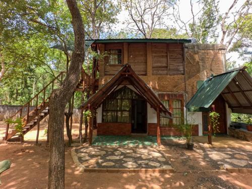 a house in the woods with a tree at Tree Nest Sigiriya in Kibissa